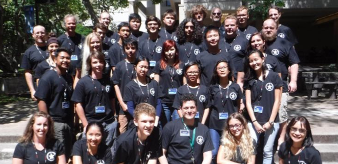 the group of participants pose on steps smiling at the camera