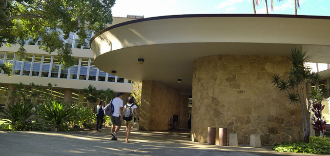 students walking toward the front entrance of the library