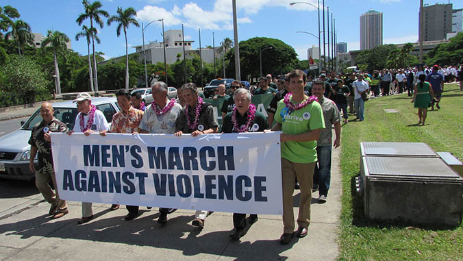 Large group of men marching against violence