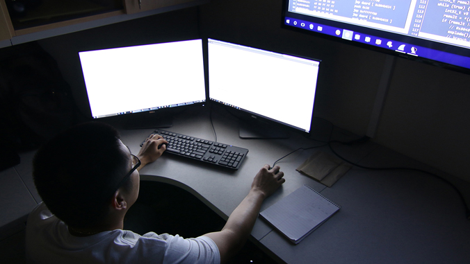 Student working on a double monitor