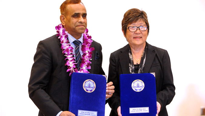 two people holding a signed agreement