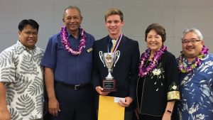 student holding science fair trophy with four other people