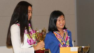 science fair winner holding trophy