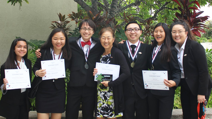 U H Manoa students holding H O S A awards