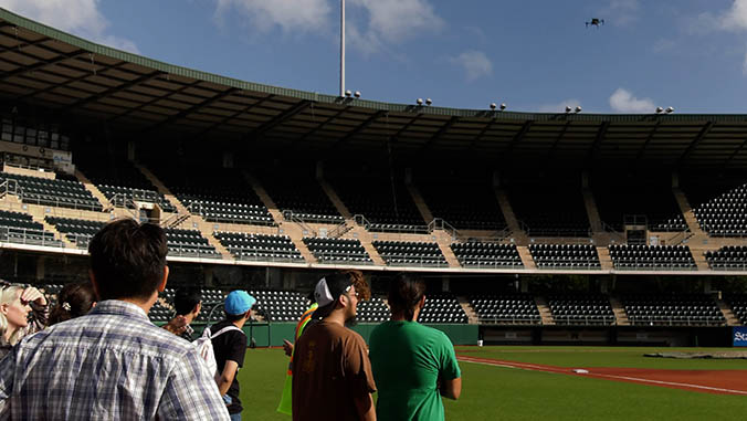 People watching a drone at Les Murakami stadium