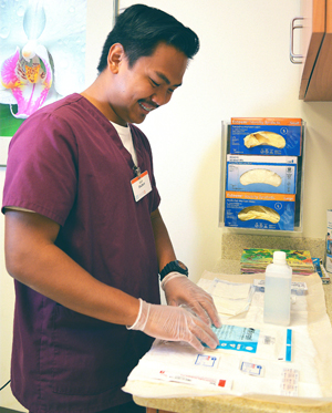 Medical assisting program intern prepping medical supplies