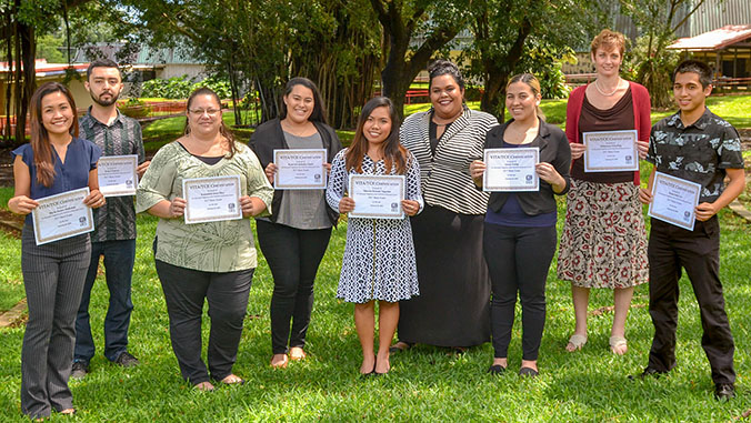 People holding certificates and smiling
