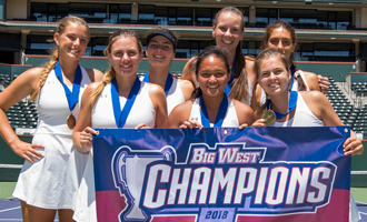 women's tennis team holding championship banner