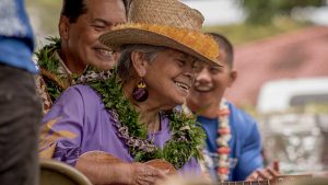 Kupuna smiling with a ukulele