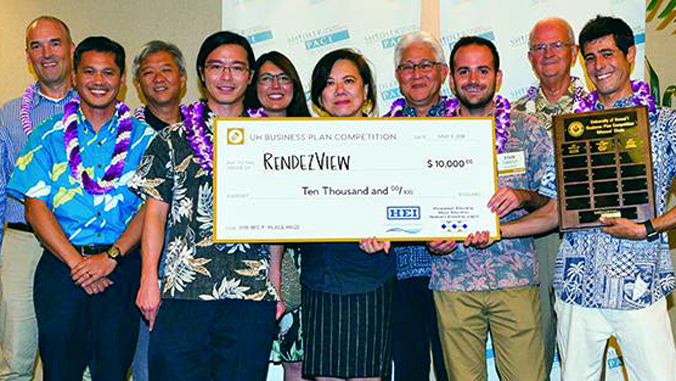 group of people holding big check