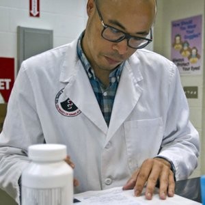 Brown reviewing a prescription