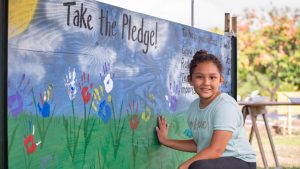 girl taking pollinator pledge