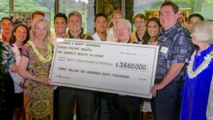 group of people with four holding a big check