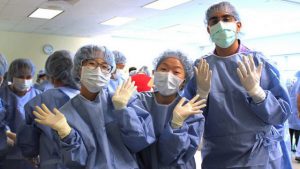 medical students wearing scrubs and gloves
