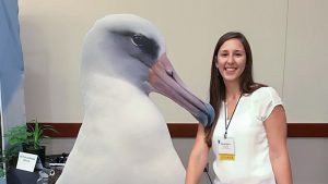 Student posing with image of a bird