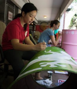 student painting garbage can