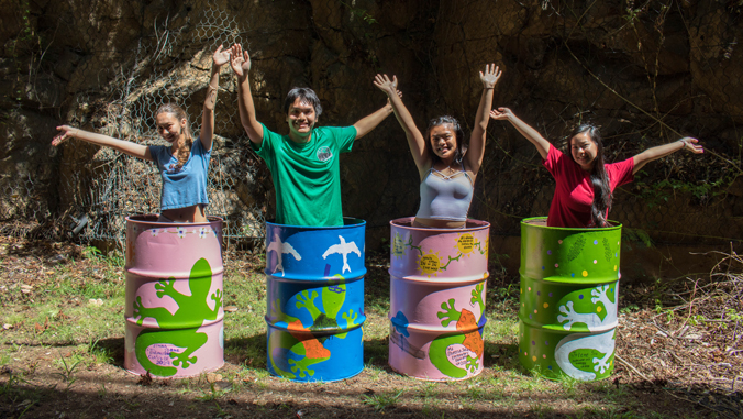 students standing in garbage cans