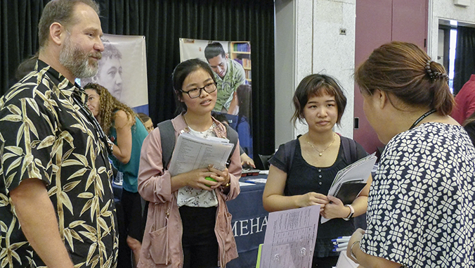 Students getting information at a table at the Career Fair