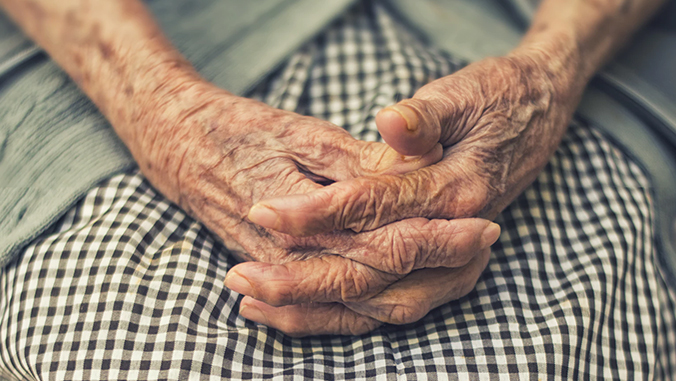 Clasped hands of an elderly person