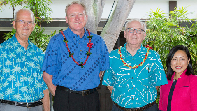 four people standing together