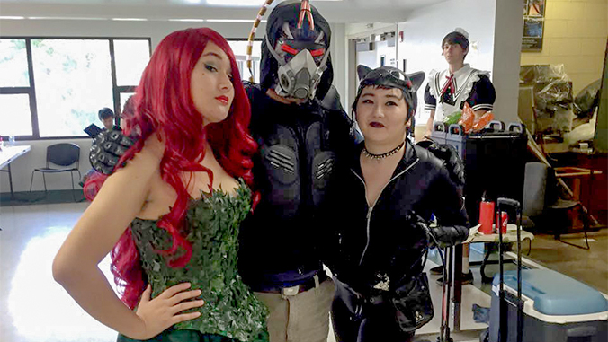 Students pose dressed as Poison Ivy, Bane and Catwoman