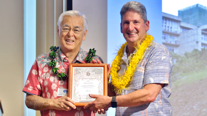 two men holding framed certificate