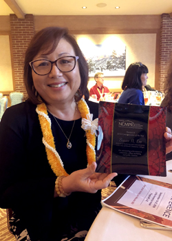 woman smiling with an award