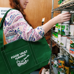 woman grabbing canned food from shelf