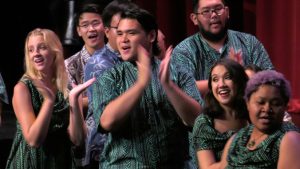 students singing and dancing to Noel