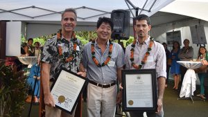 three males holding certificates from the Honolulu City Council
