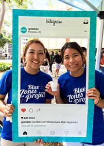 Two smiling students posing in an instagram frame
