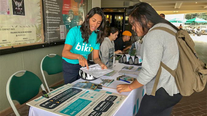 Student learning about Biki at an information table