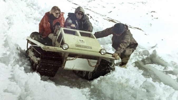 people riding on a snow mobile