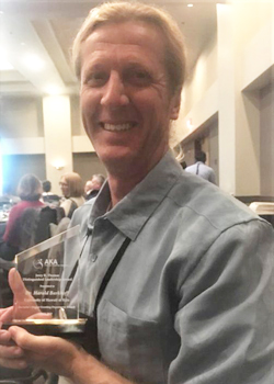 professor with his award