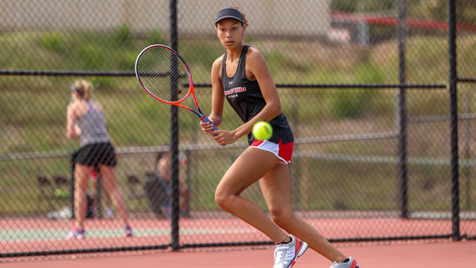 student playing tennis