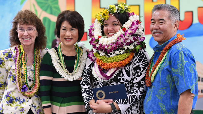 4 people wearing lei