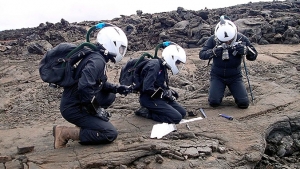 Researcher in space suits taking samples