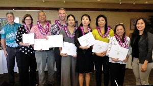 group of people holding certificates