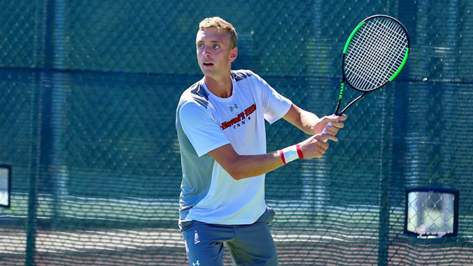 student playing tennis