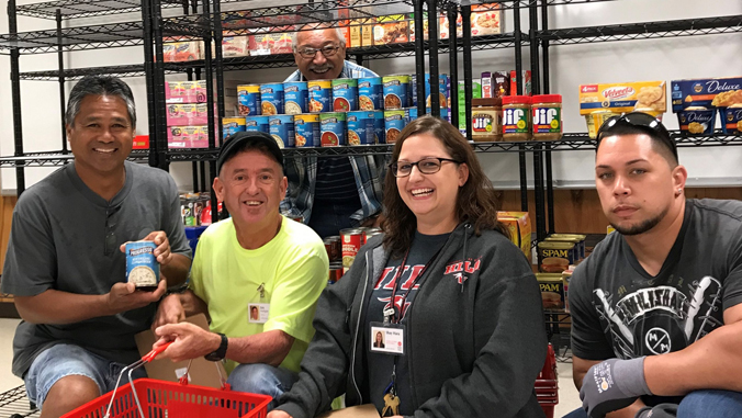 people smiling in the food pantry