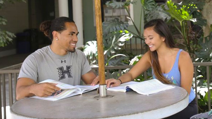 Male and female student studying.