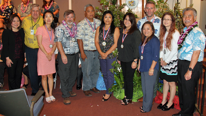 group of people, most wearing award medal