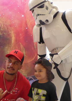 parent and child posing with stormtrooper