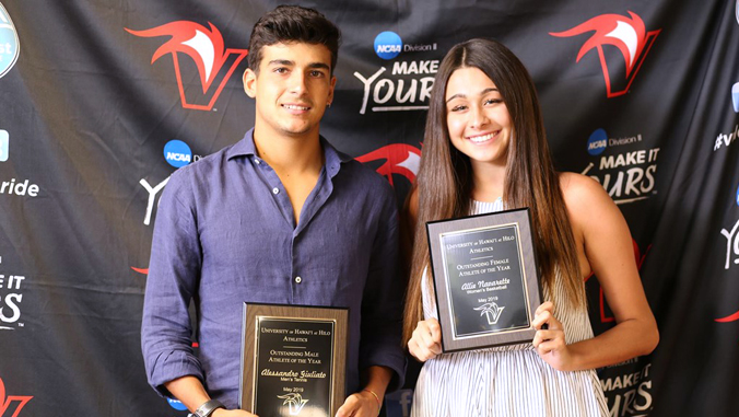 two people holding award plaque