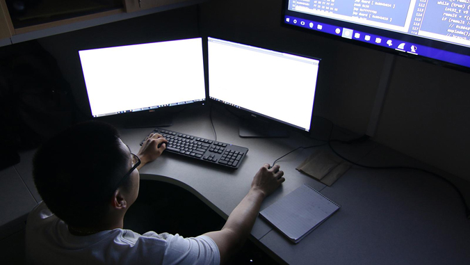 person sitting at a computer