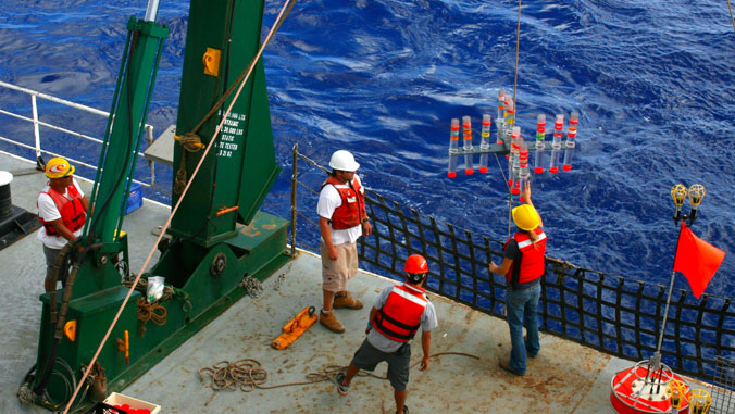 Scientists working on a research boat at sea