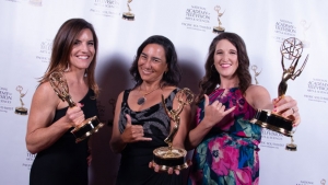 Three women holding Emmy awards, click for larger image