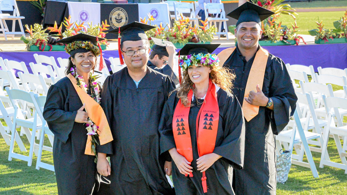 four student in regalia