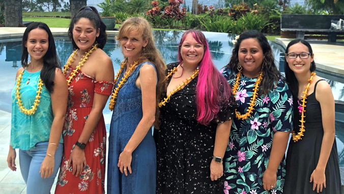 six women wearing lei
