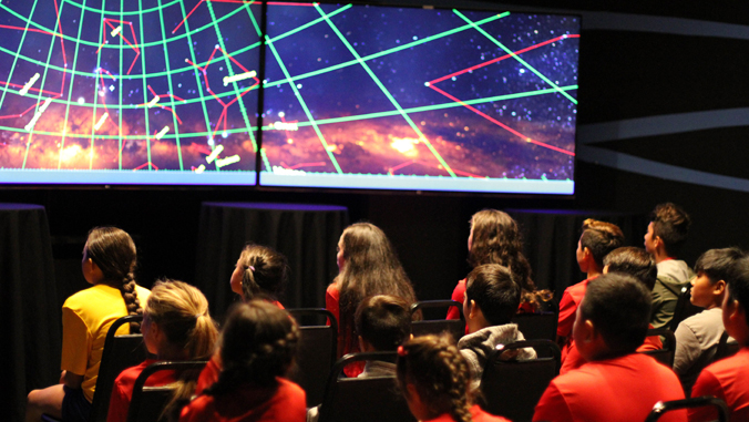 children looking at star on a screen